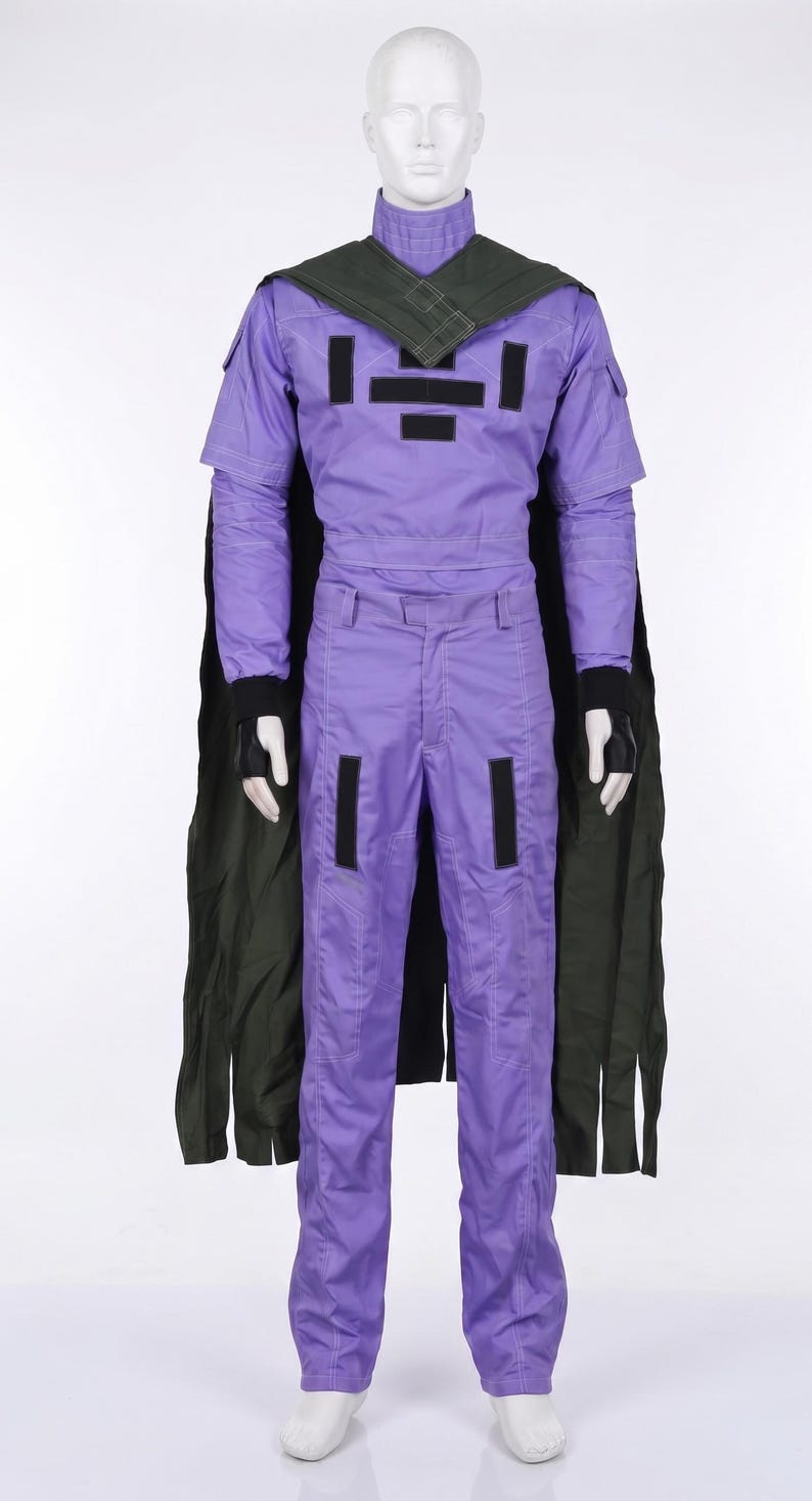 May include: A purple long-sleeved jumpsuit with a high collar, featuring black rectangular patches on the chest and thighs. A dark green cape is attached at the shoulders, and black fingerless gloves are worn on the hands of the white mannequin.