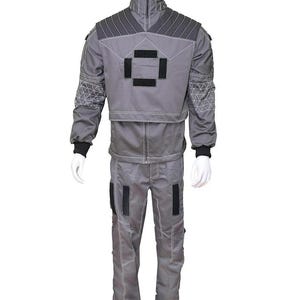 May include: A gray two-piece uniform set consisting of a long-sleeved jacket and matching trousers. The jacket features a high collar, dark gray shoulder panels with stitching, and black rectangular patches on the chest and sleeves.