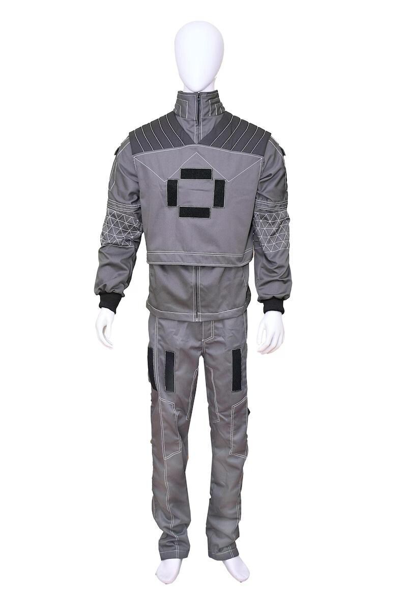May include: A gray two-piece uniform set consisting of a long-sleeved jacket and matching trousers. The jacket features a high collar, dark gray shoulder panels with stitching, and black rectangular patches on the chest and sleeves.