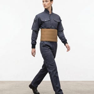 May include: A trio of ceramic mugs with a speckled, matte finish in cream, light grey, and dark grey. The mugs have a simple, minimalist design, suitable for coffee or tea.