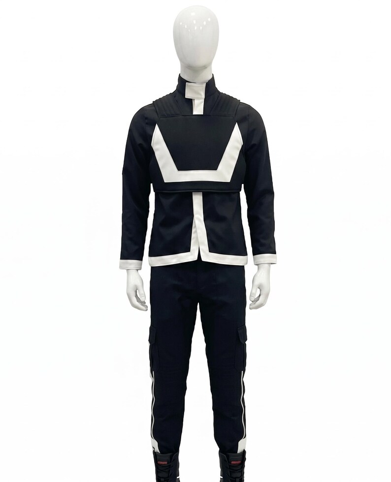 May include: A dark navy blue long-sleeved jacket with a high collar and a white geometric chest panel, paired with matching dark navy blue cargo pants featuring white vertical side stripes and side pockets, displayed on a white mannequin.
