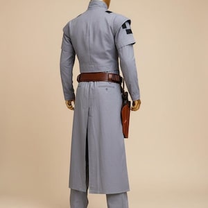 May include: A set of three ceramic mugs with a speckled, matte finish. The mugs are in shades of cream, light gray, and dark gray. Each mug has a simple, minimalist design, perfect for coffee or tea.