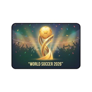 May include: A rectangular mousepad featuring a golden soccer ball atop a stylized trophy. The background shows a crowd of cheering fans and confetti. The text "WORLD SOCCER 2026" is displayed at the bottom.