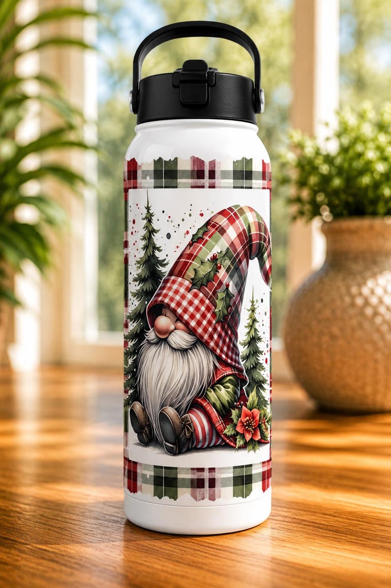 May include: White insulated water bottle with a black handle and lid. The bottle features a festive gnome design with a red and green plaid pattern, Christmas trees, and a red poinsettia. The top and bottom have a matching plaid border.