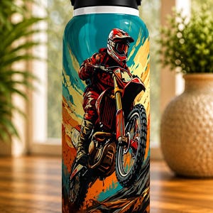May include: White water bottle featuring a vibrant illustration of a motocross rider in red gear on a red and black dirt bike. The design includes a colorful background with orange, yellow, and blue hues, and a black lid.