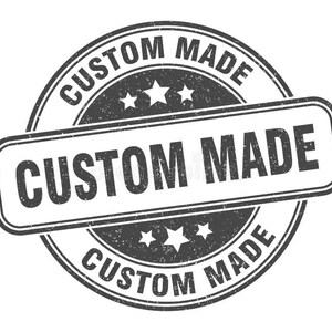 May include: A distressed, circular stamp with the words "CUSTOM MADE" in a bold, sans-serif font. The text is arranged in a circular pattern and also in a rectangular shape. The stamp features three stars and a grunge texture.