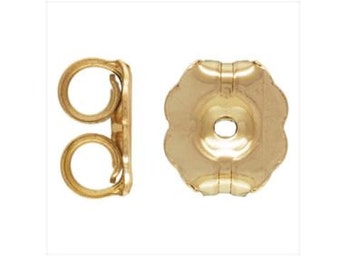May include: A pair of gold-tone earring backs. One back is a butterfly style with a post hole. The other back is a standard push-back style.