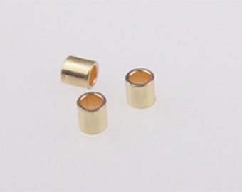 May include: Three gold-colored metal tube beads. The beads are hollow and have a shiny finish.