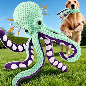 May include: A large, mint green and purple plush octopus dog toy with white spots on its tentacles. A golden retriever dog is in the background, holding a smaller green toy. The octopus has black button eyes and is on a green lawn.