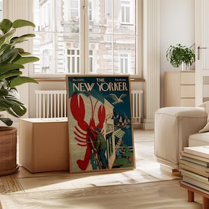 Puede incluir: Una portada enmarcada de la revista vintage "The New Yorker" con una ilustraci&oacute;n de langosta roja. La portada incluye el texto "Lobster" y una escena costera con una gaviota. El marco es de color madera natural.