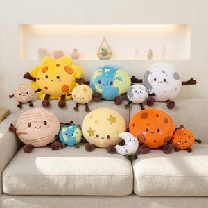 May include: A collection of plush toys shaped like celestial bodies, including a yellow sun, a blue and green Earth, a gray moon, a striped beige planet, a yellow star-patterned sphere, and an orange planet, all featuring smiling faces.