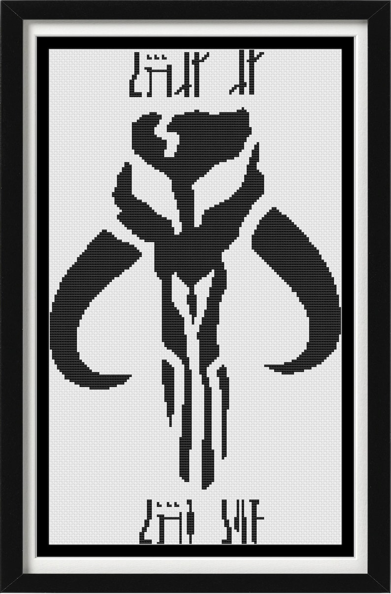 May include: A framed cross-stitch pattern featuring a black Mythosaur skull symbol centered on a white background. Above and below the central icon are lines of black text written in the Aurebesh script, all enclosed within a simple black frame.