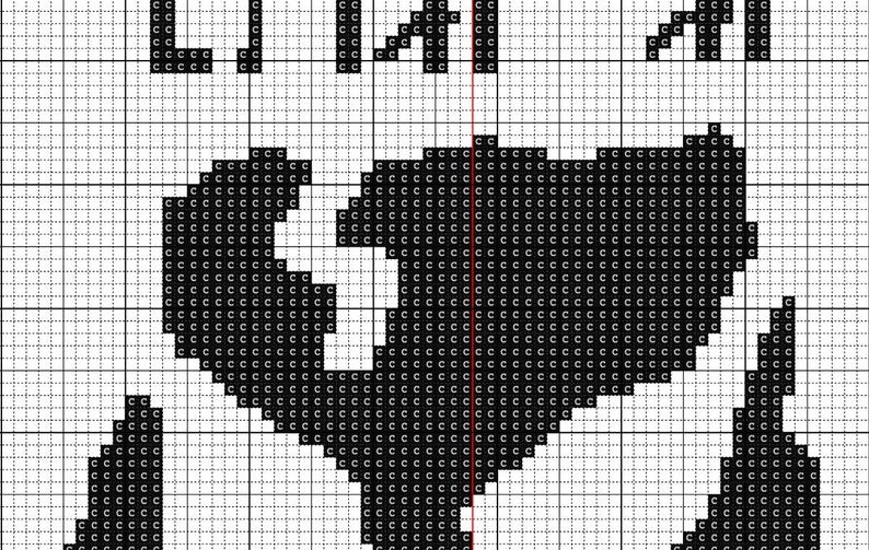May include: A cross-stitch pattern printed on a white grid background. The design features a large, solid black heart shape composed of individual 'c' characters. The letters 'L I A I' are visible at the top, and a thin red vertical line divides the heart.