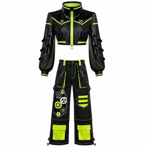 May include: Black and neon green two-piece outfit. The cropped jacket has a high collar and zip closure, with neon green trim. The trousers feature multiple pockets and decorative gear and circle designs. The outfit is made of a shiny material.