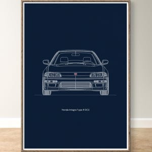May include: A framed print featuring a white line drawing of a Honda Integra Type R DC2 car on a dark blue background. The car is viewed head-on, showcasing its headlights, grille, and windshield. The text "Honda Integra Type R DC2" is at the bottom.