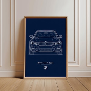 May include: A framed print showing a white line drawing of a BMW 320d M Sport car on a dark blue background. The car's front view is detailed, with the BMW logo and text at the bottom. The frame is a light wood colour.