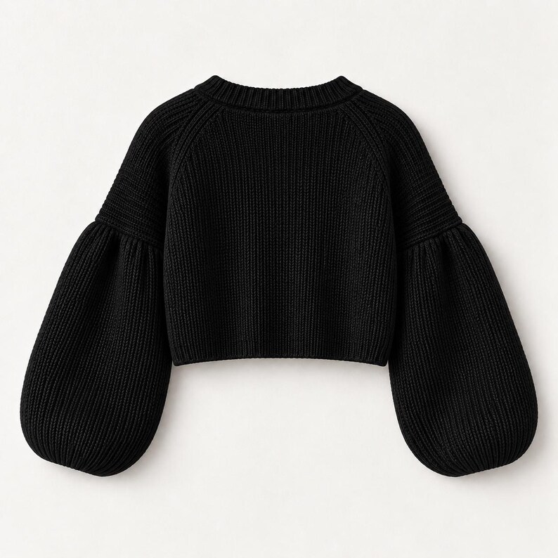 May include: A black long-sleeve sweater featuring a ribbed knit texture, a crew neckline, and voluminous balloon sleeves. The garment has a cropped length and a solid black color throughout, showcasing a consistent knit pattern.