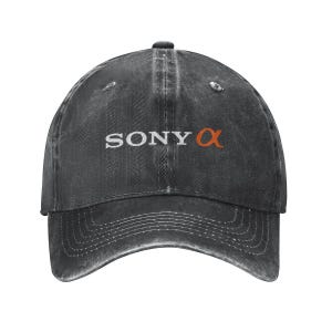 May include: A charcoal gray baseball cap with a distressed, washed-out finish. The front features the white text SONY followed by an orange alpha symbol. The cap has a curved brim with visible stitching and a six-panel construction with eyelets.