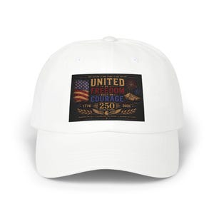 May include: White baseball cap featuring a rectangular patch with the text "UNITED BY FREEDOM BUILT ON COURAGE 250 YEARS STRONG" and an American flag design. The cap also has the years 1776 and 2026.