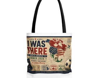 Op de afbeelding: Een witte tote bag met zwarte hengsels voorzien van een afbeelding van een kaart van Noord-Amerika met de tekst I WAS THERE NORTH AMERICA SUMMER 2026. Het ontwerp bevat een voetbal, paspoort en stempels voor de VS, Canada en Mexico.