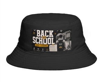 Op de afbeelding: Een zwarte bucket hat met een rechthoekige grafische print op de voorzijde. Het ontwerp bevat de tekst BACK TO SCHOOL HIGH SCHOOL, een persoon met een rugzak, een checklist en een schuimvinger. De afbeelding bevat ook kleine sterren.