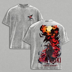 May include: A gray, short-sleeved t-shirt featuring a crow graphic on the front and a vibrant anime-style design on the back. The back design includes a character in a black cloak, flames, and the text "AKATSUKI" and "ITACHI UCHIHA".