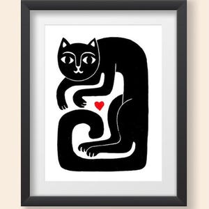 May include: A framed print featuring a stylized black cat illustration on a white background. The cat is depicted in a seated, curved posture with a small, solid red heart positioned between its front paws and its long, curled tail.