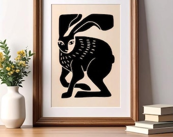 May include: A framed wall art print featuring a stylized black silhouette of a hare on a light beige background. The hare is depicted in a side profile with long ears and textured markings on its chest, enclosed in a simple wooden frame.