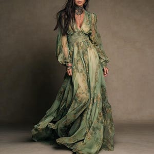 May include: A flowing, floor-length dress in shades of green with a floral pattern. The dress features long, billowy sleeves and a V-neckline. The fabric appears lightweight and sheer, creating a romantic and ethereal look. The dress is suitable for special occasions.