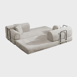 May include: A light gray convertible sofa with black metal handles and accents. The sofa is modular, with sections that can be arranged in different configurations. Includes two cylindrical bolsters and a small square pillow.