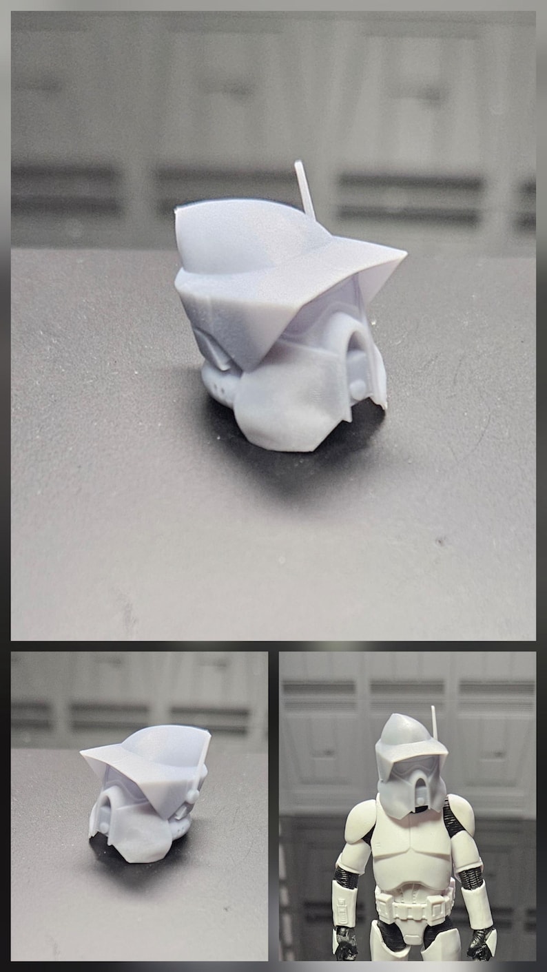 Puede incluir: Un accesorio de casco de resina gris claro sin pintar que presenta una visera ancha y una antena delgada, dise&ntilde;ado para una peque&ntilde;a figura de acci&oacute;n. El casco tiene una forma angular distintiva y se muestra tanto solo como en una figura blanca.