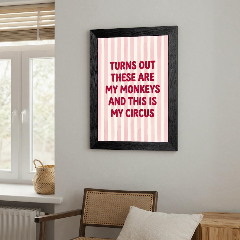 May include: A framed print with the text "TURNS OUT THESE ARE MY MONKEYS AND THIS IS MY CIRCUS" in burgundy letters. The background has vertical pink and white stripes. The frame is black.