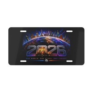May include: Black license plate featuring a vibrant graphic of a soccer ball with the number "2026" in large, metallic lettering. The design includes city skylines and the text "ONE WORLD. ONE STAGE. ONE LEGACY."