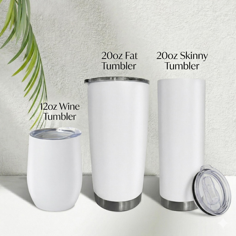 May include: Three white insulated tumblers of different sizes are displayed. The tumblers include a 12oz wine tumbler, a 20oz fat tumbler, and a 20oz skinny tumbler. Each tumbler has a silver-colored base and a lid. The text on the image reads: "20oz Fat Tumbler", "20oz Skinny Tumbler", and "12oz Wine Tumbler".