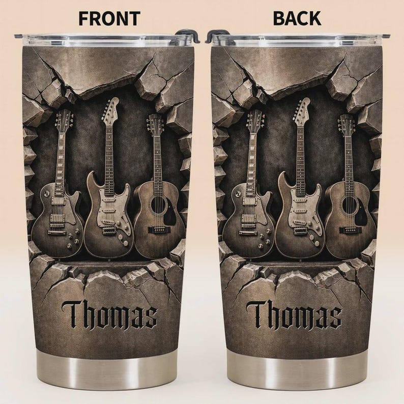 May include: Stainless steel tumbler featuring a design of three guitars emerging from a cracked stone wall. The name "Thomas" is displayed in a carved font at the bottom. The design is in shades of brown and gray.