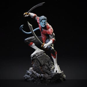 May include: A figurine of a blue-skinned character in a dynamic pose, holding two curved swords. The figure wears a red and black suit with white accents and stands on a rocky base. The character has a tail and is in a fighting stance.