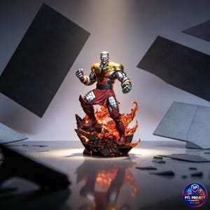 May include: A Colossus action figure stands on a fiery base. The figure has a silver head and metallic armor with gold accents. He wears a red tunic and boots. The base is a dark, rocky structure with orange flames. The background is a light gray with dark gray geometric shapes.