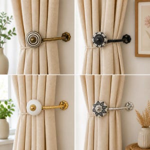 May include: A collection of four curtain holdbacks featuring decorative ceramic knobs in various patterns, including black and white stripes, floral motifs, and solid white, attached to curved metal arms in brass, black, and silver finishes.