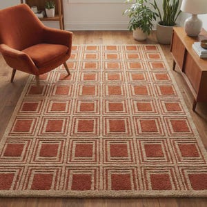May include: A rectangular area rug featuring a repeating geometric pattern of nested squares in shades of burnt orange and beige. The rug has a textured, tufted pile construction with clean lines and a consistent grid layout covering the entire surface.