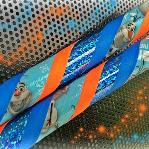 May include: Two twisted ribbons with a blue, orange, and glitter design. One ribbon features the character Olaf from the movie Frozen, snowflakes, and the text "I EXPRESS ON THE JOY". The other ribbon has a glittery blue design.
