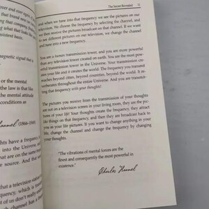 May include: Open book with text from "The Secret Revealed" on a white page. The text discusses frequency, thoughts, and their impact on life. Includes a quote by Charles Haanel.