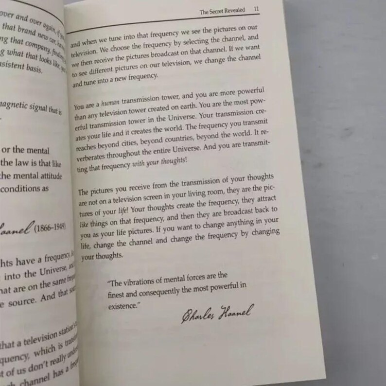 May include: Open book with text from "The Secret Revealed" on a white page. The text discusses frequency, thoughts, and their impact on life. Includes a quote by Charles Haanel.