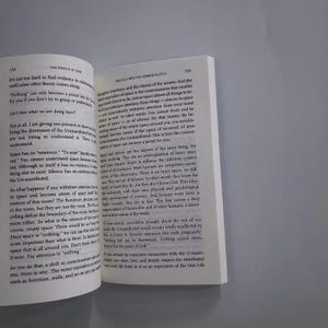 May include: Open book with text on white pages. The text discusses concepts of space, silence, and the Unmanifested. The book is open to pages 138 and 139, with the title "The Power of Now" visible.