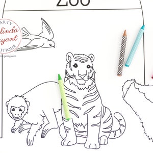 May include: A black and white coloring page with a zoo theme, featuring outlines of a tiger, monkey, fox, and other animals. Three polka-dot crayons in brown, blue, and pink are placed on the page. The text "ZOO" is visible.