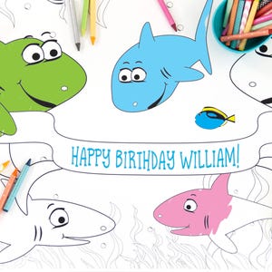 May include: A coloring page featuring a banner that says "Happy Birthday William!" with four sharks and a small fish. The sharks are outlined and ready to be colored in. The sharks are green, blue, pink, and white. The fish is blue.