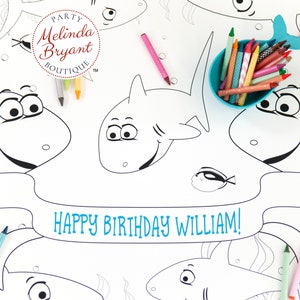 May include: A black and white coloring page featuring sharks and a banner that says "Happy Birthday William!" The page is surrounded by a dotted pattern.