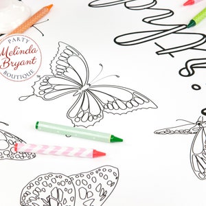 Detail of a butterfly with two crayons for scale. The butterfly is about five inches wide.