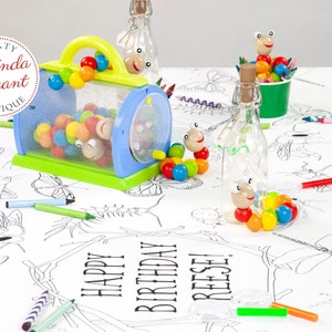 A fun table set with polka dot table cloth and overlayed with a table length, personalized, coloring banner. The design is realistic line drawings of common insects. Also set on the table: a bug catcher filled with toy caterpillars & cups of crayons.