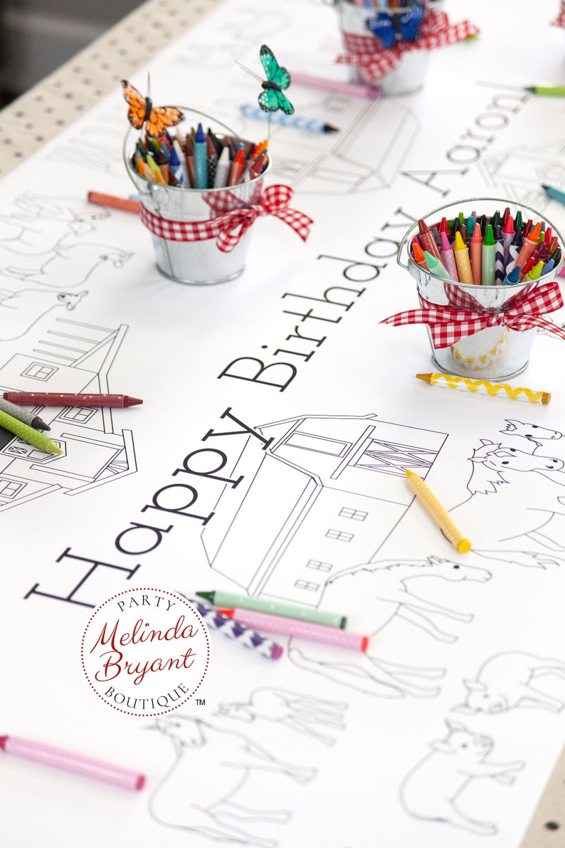 This table length view of my farm coloring table runner features horses, pigs, sheep, and a barn. The illustrated scene runs the length of the runner on both sides of the table. It is staged with miniature milk buckets filled with crayons.