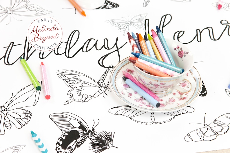 A pretty teacup and saucer filled with crayons are an invitation to sit down and color this pretty butterfly table runner.